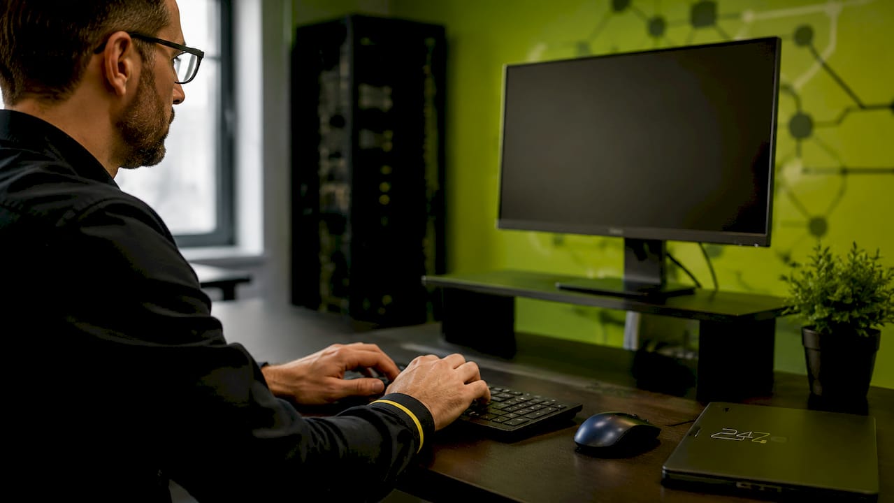 Engineer typing firewall configuration in IT center