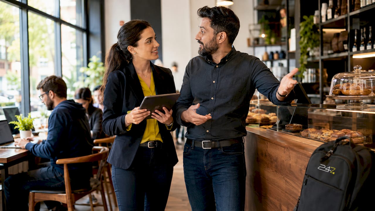 Two IT professionals discussing staffing savings