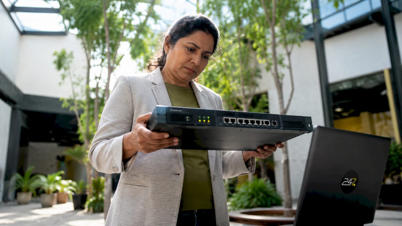 IT specialist examining firewall hardware