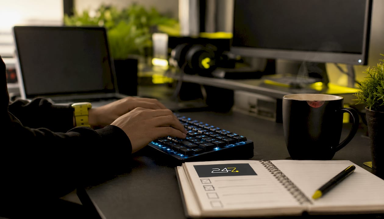 Hands typing compliance checklist in IT workspace