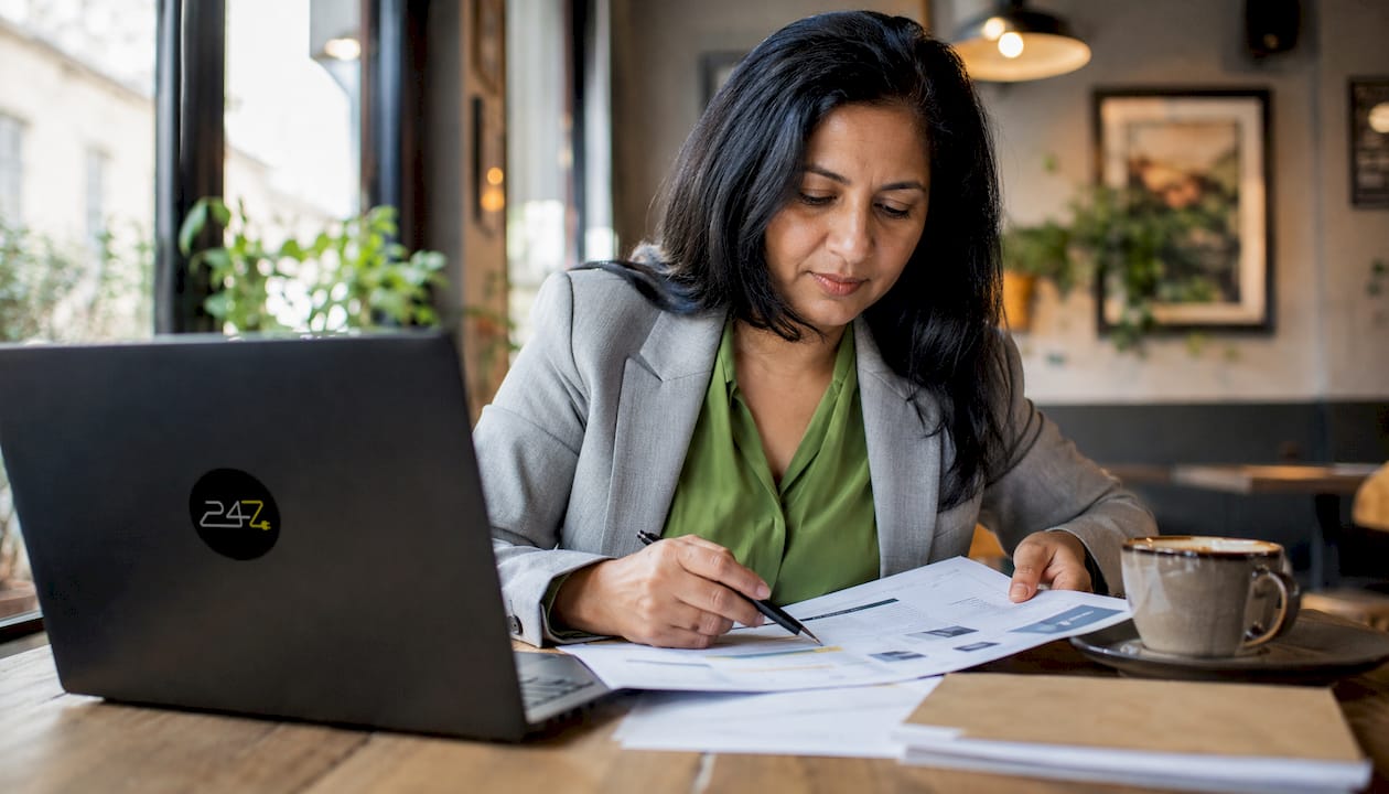 Woman reviewing managed IT cybersecurity reports