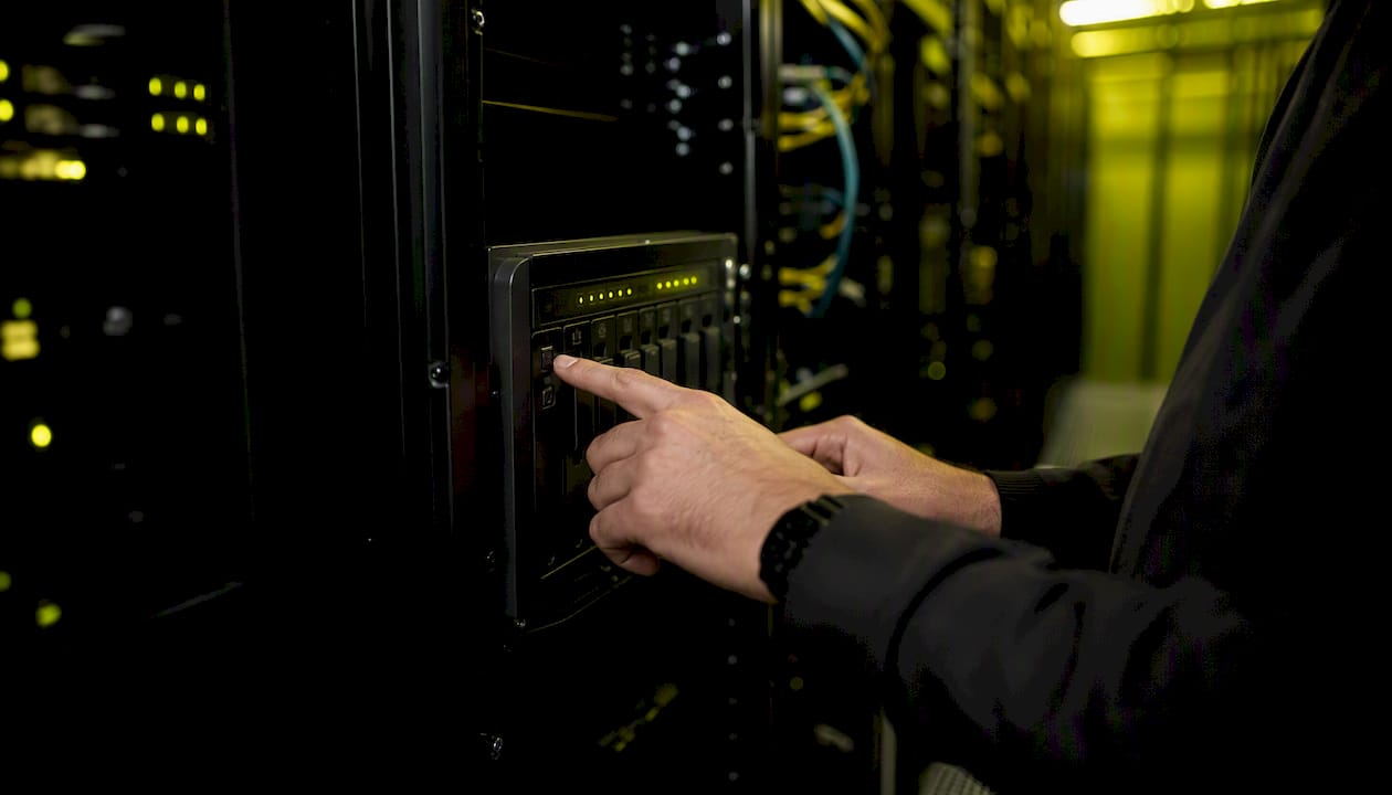 Hands operating NAS restore test controls