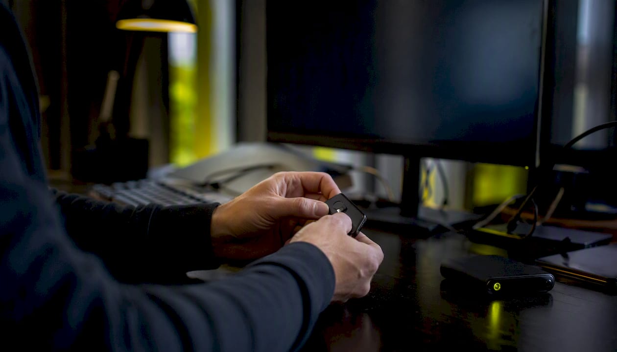 Hands adjusting security token device in IT center