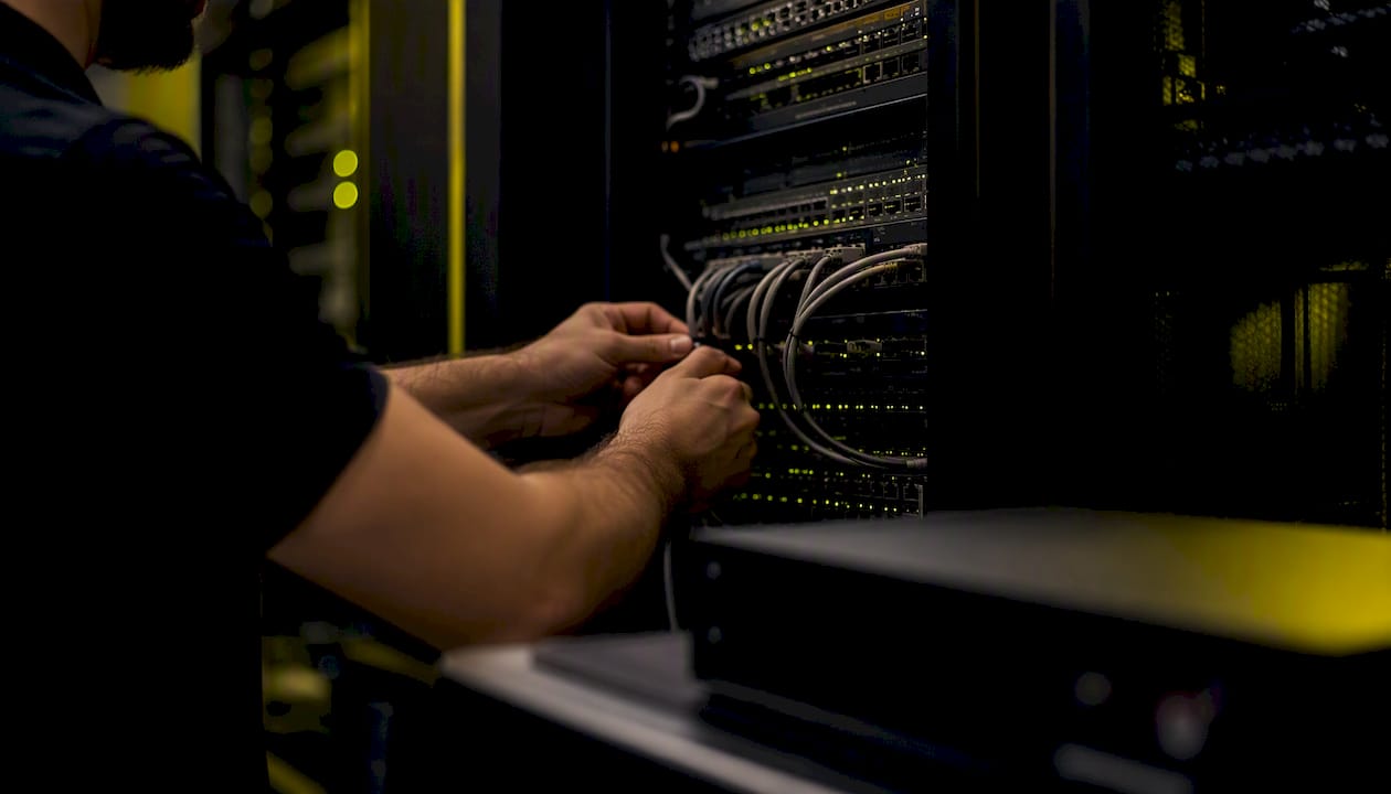 Hands labeling server cables in IT room
