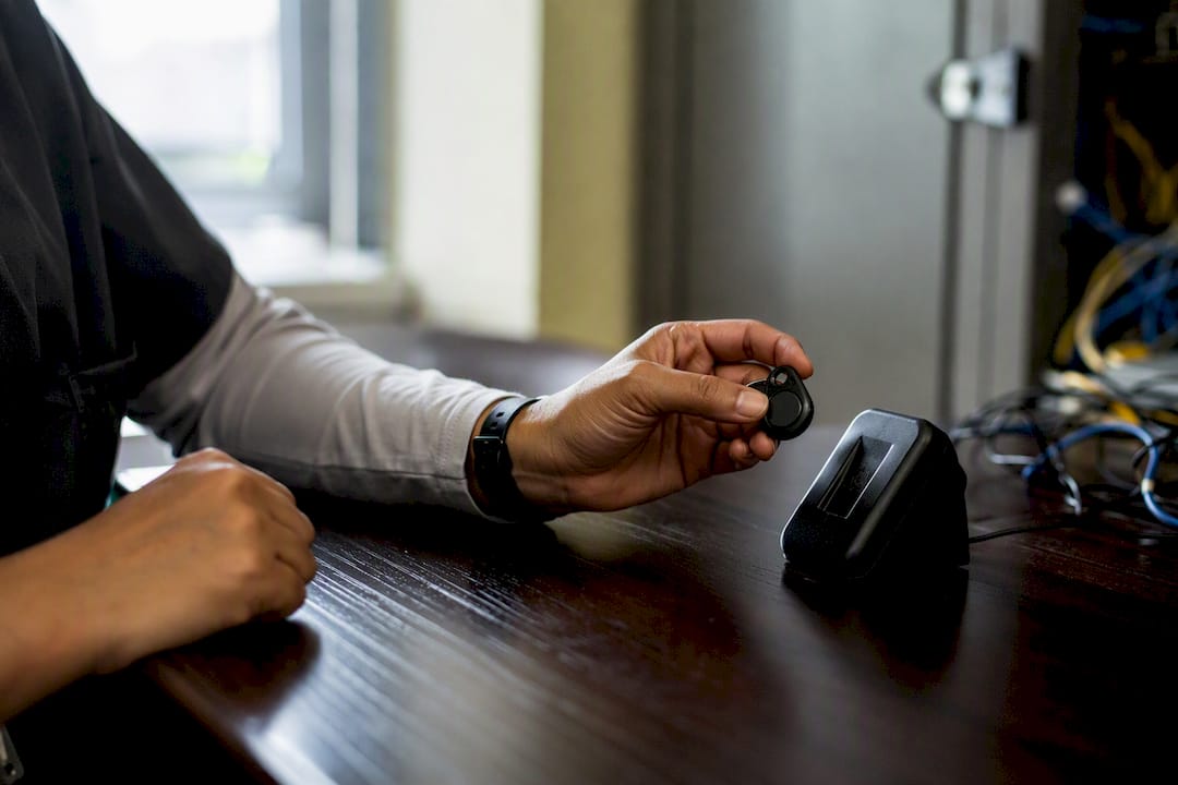 Hands using security token near badge reader