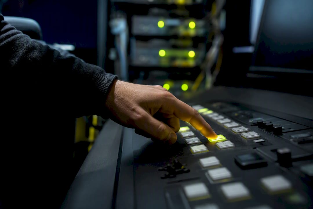 Hand pressing automation console button in IT center