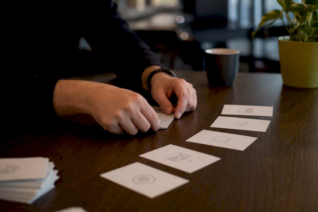 Hands arranging phishing training cards