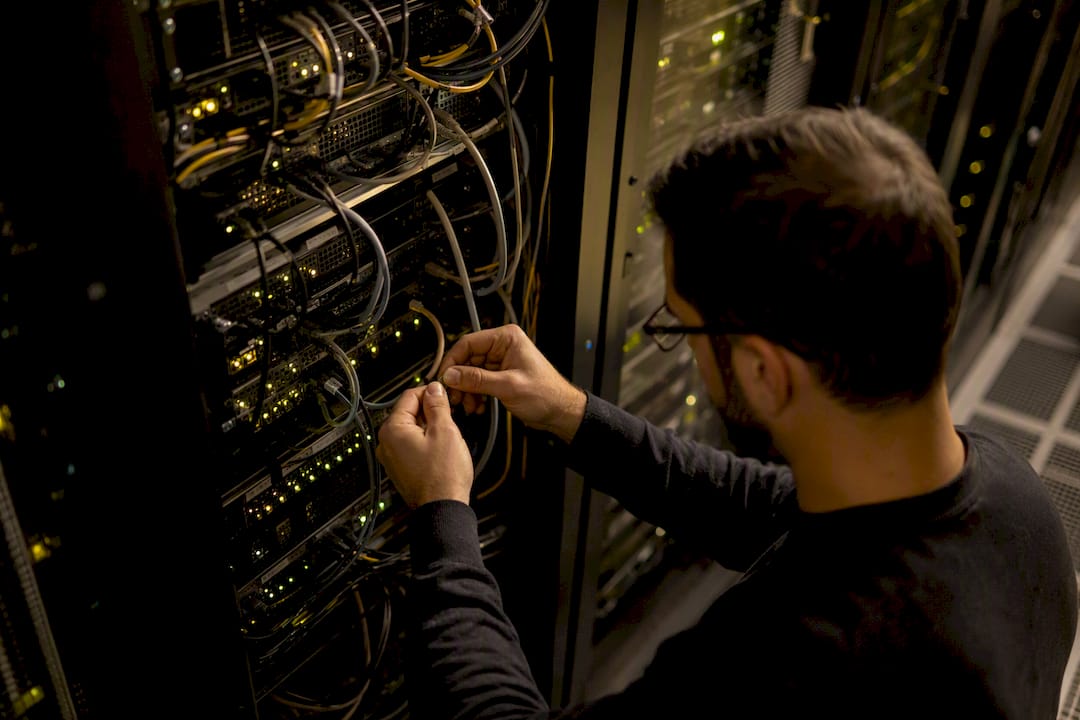 Hands labeling network cables in data center