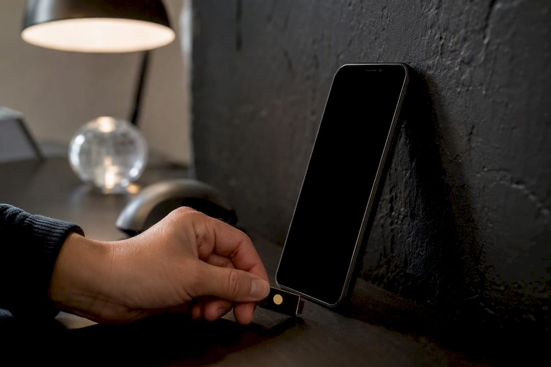 Hand inserting security token into phone