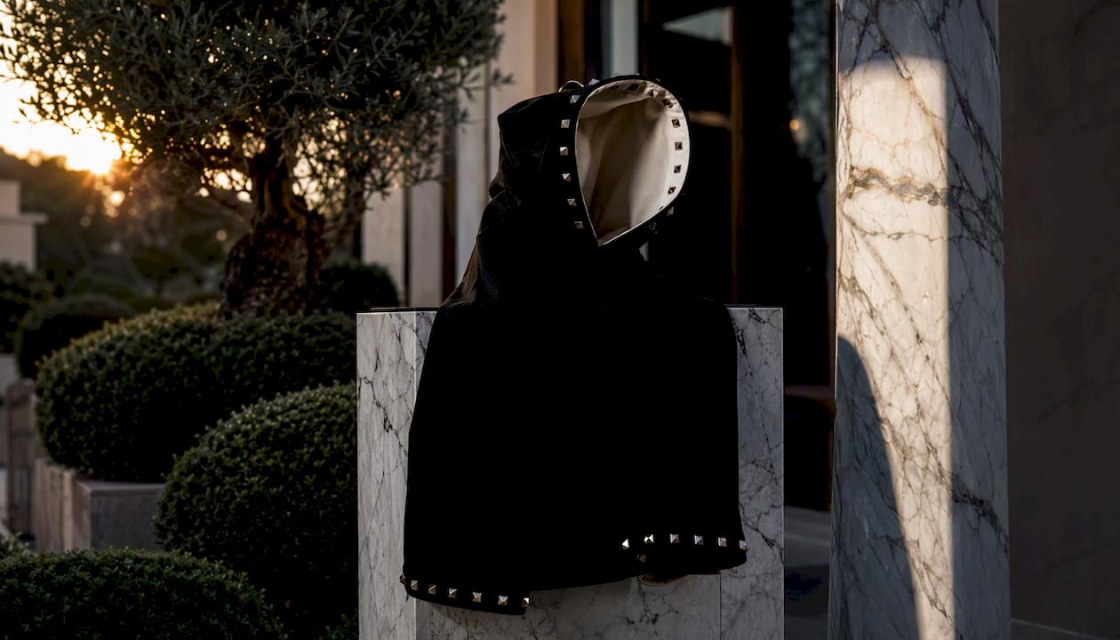 Hoodie silhouette on marble pedestal