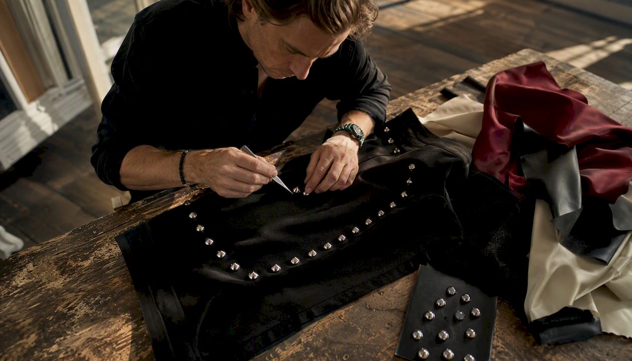 Artisan aligning Italian cones on garment