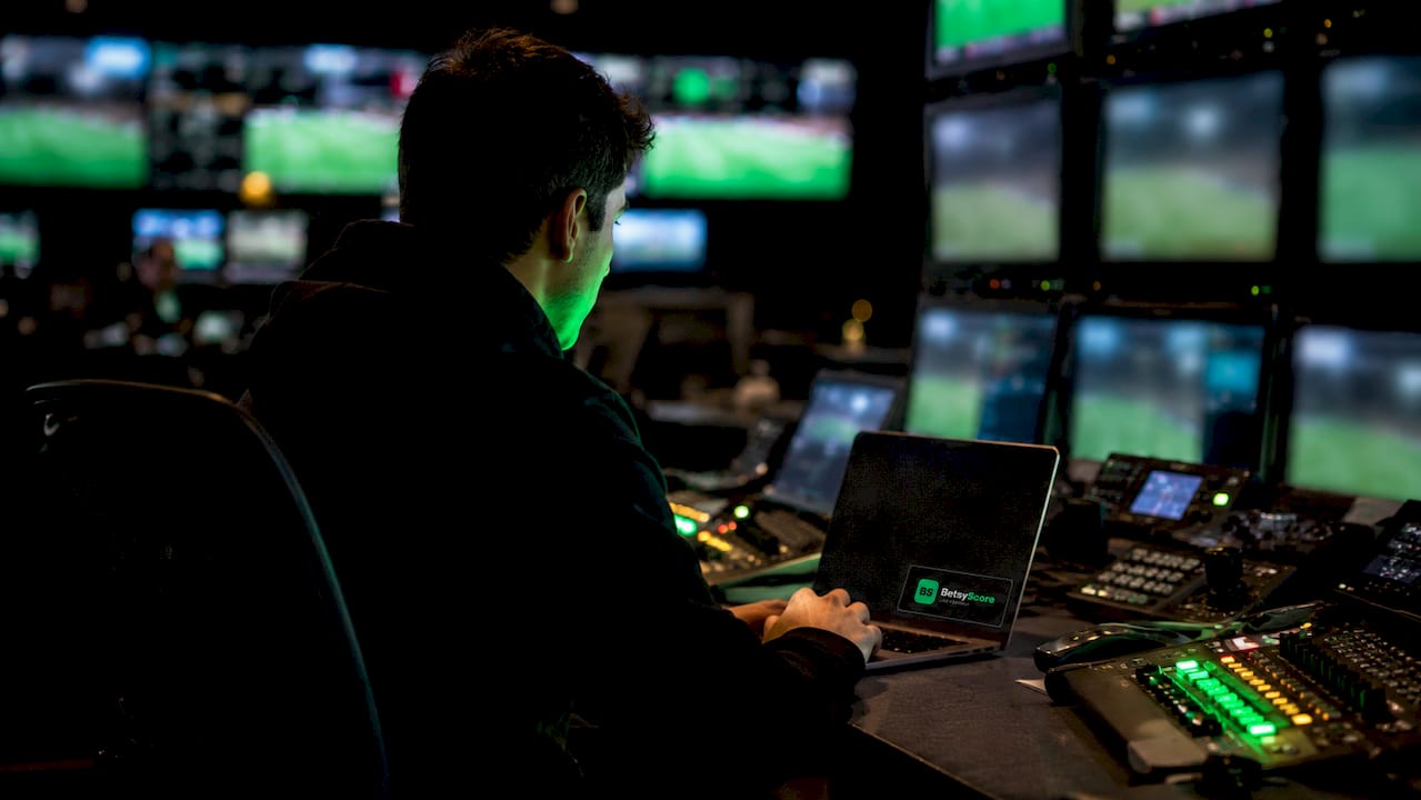 Technician monitoring live football score systems