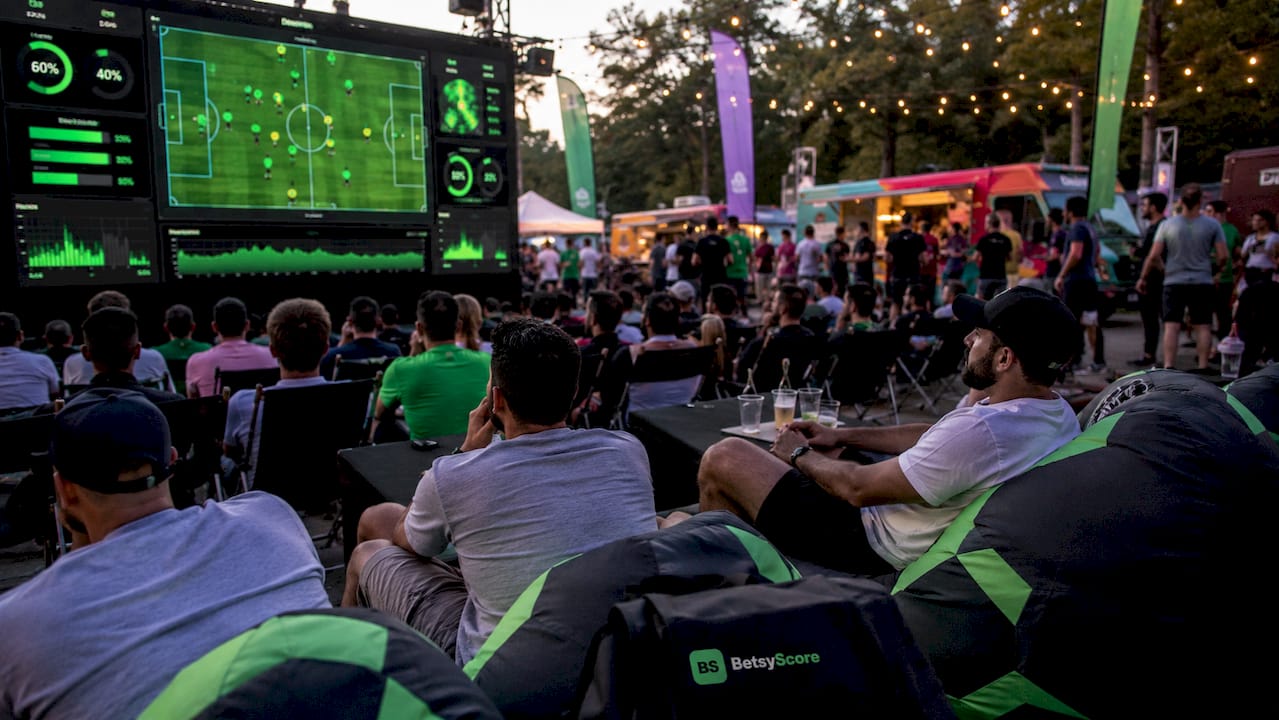 Live football match stats displayed on stadium control screens