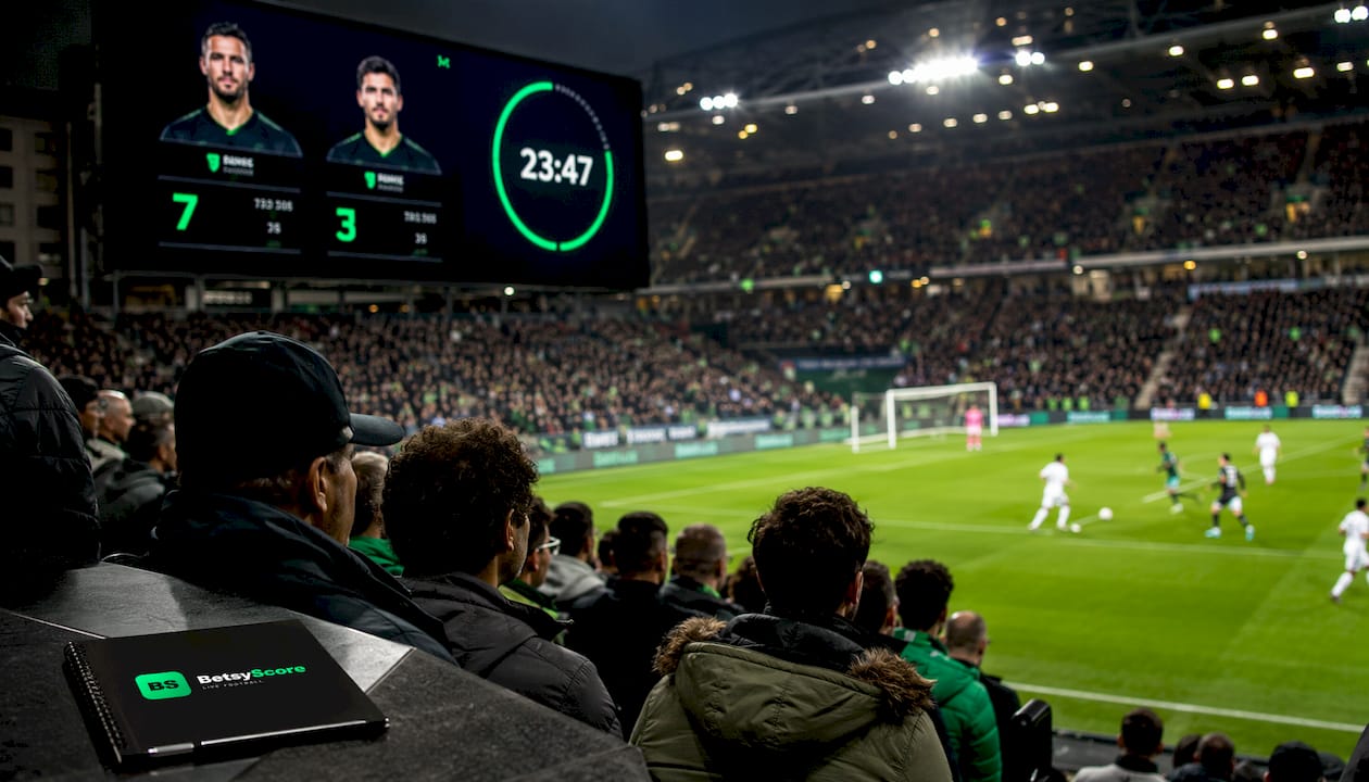 Football stadium scoreboard showing player goal stats