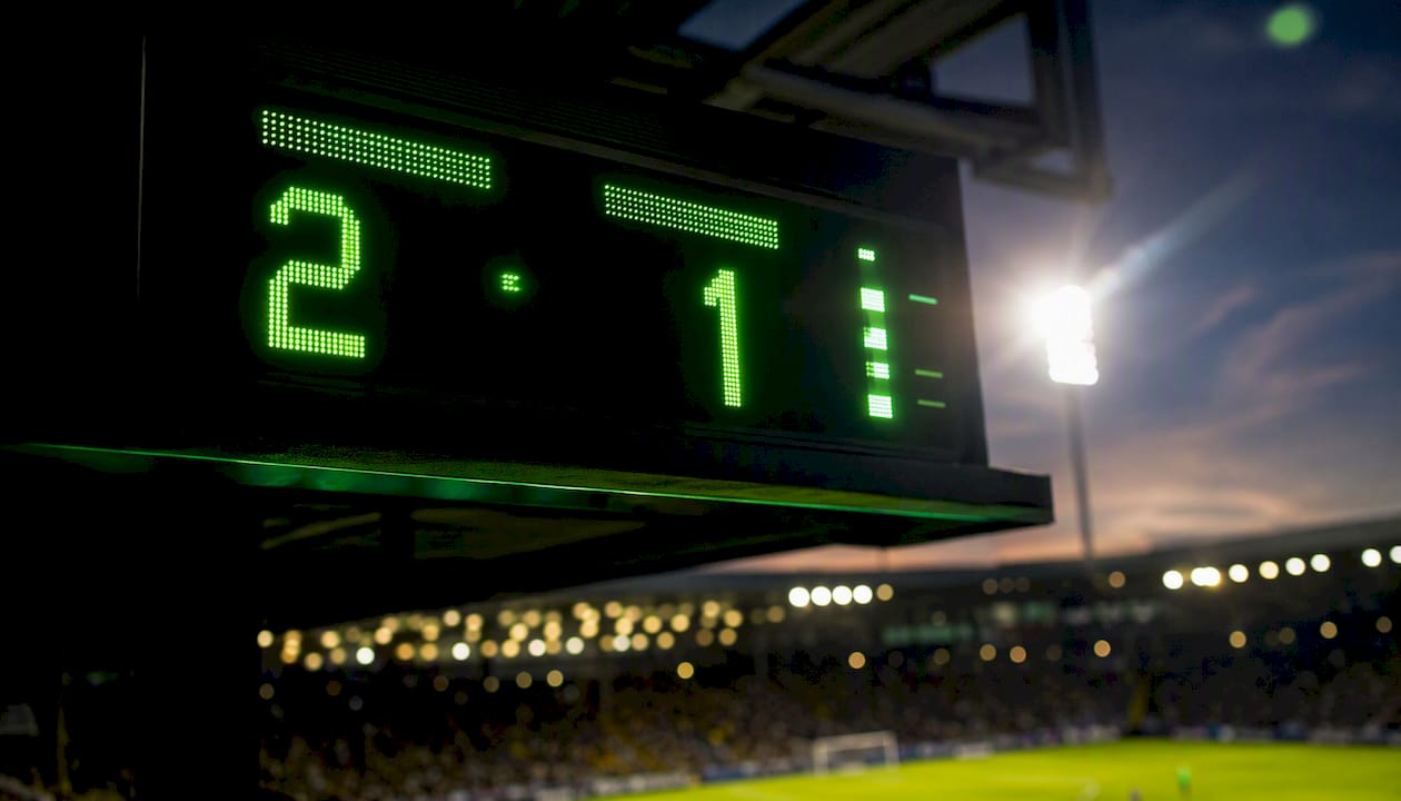 Digital live scoreboard showing match stats at stadium