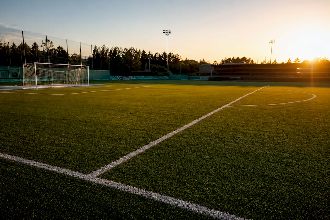 Penalty area lines on football pitch close-up