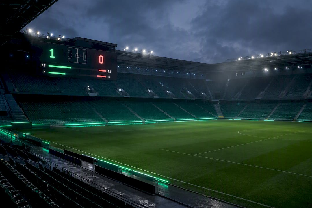 Digital football stadium scoreboard at night