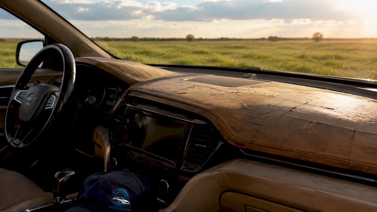Sun-damaged cracked car dashboard close-up
