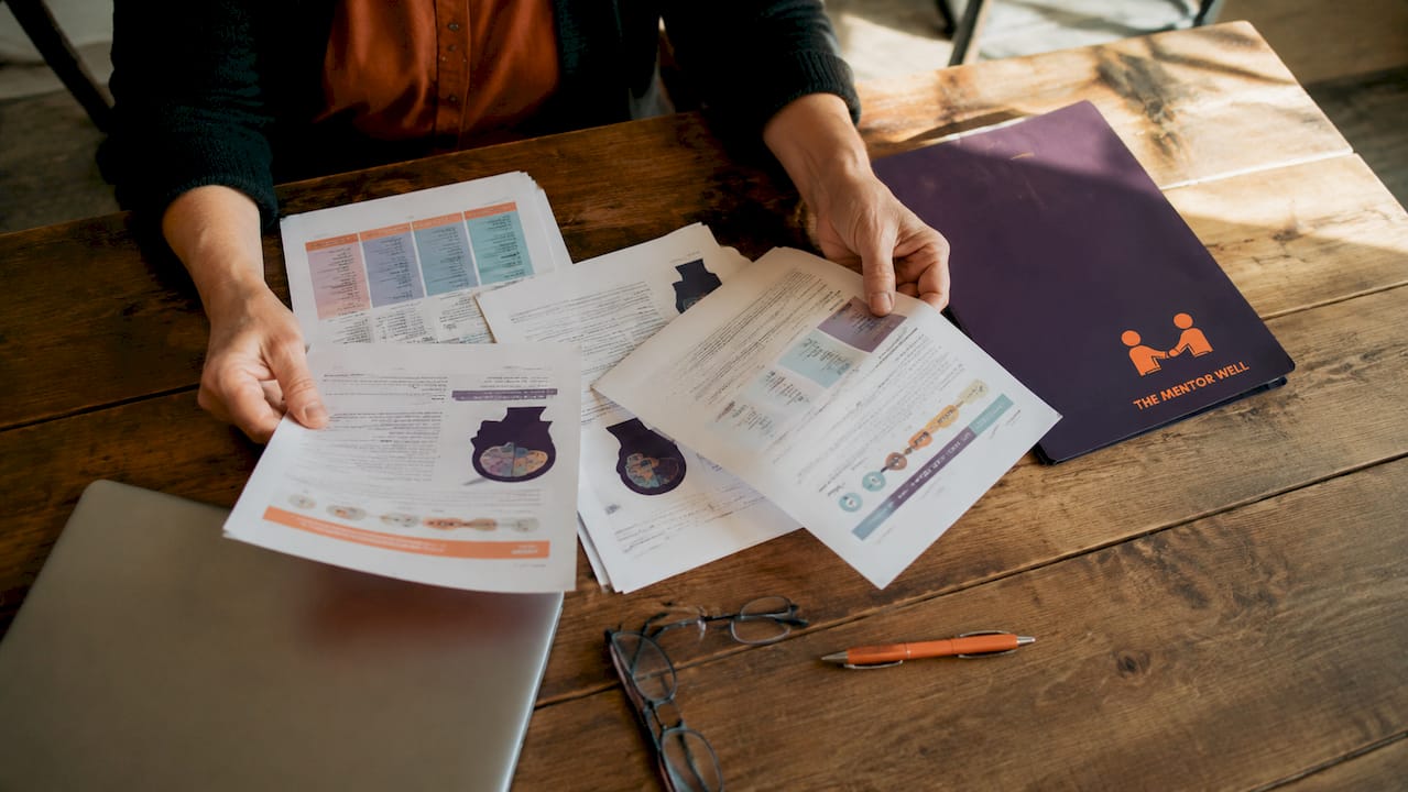 Hands sorting mental health planning papers