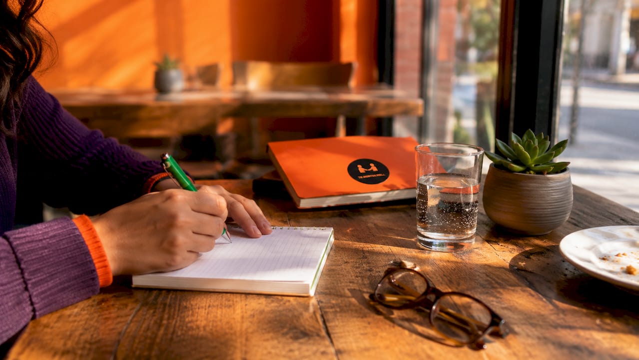 Volunteer taking handwritten notes in a break room