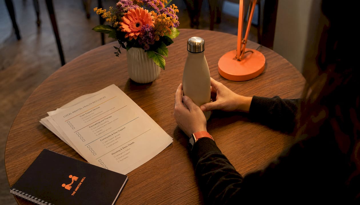 Young hands near mental health resources and phone