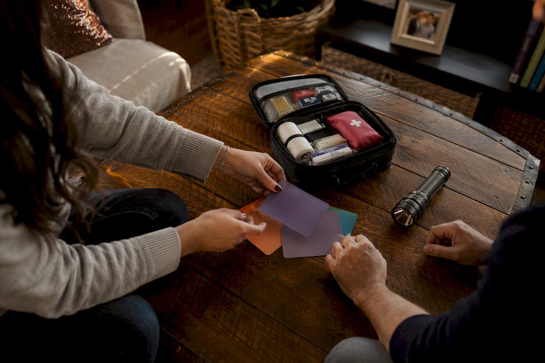 Hands arranging objects in family safety drill