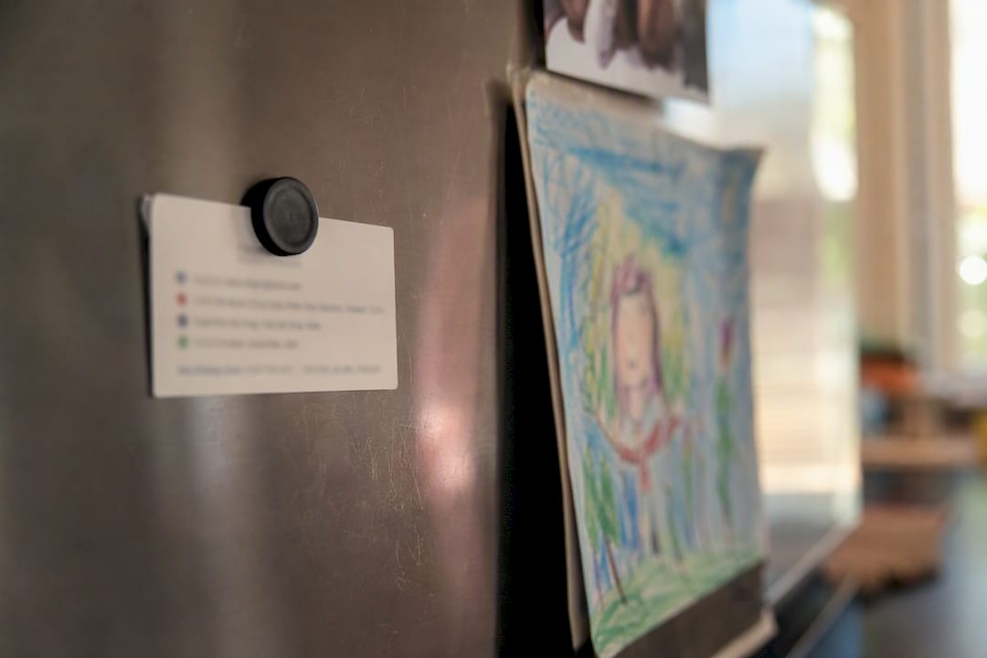 Emergency contact card on fridge door