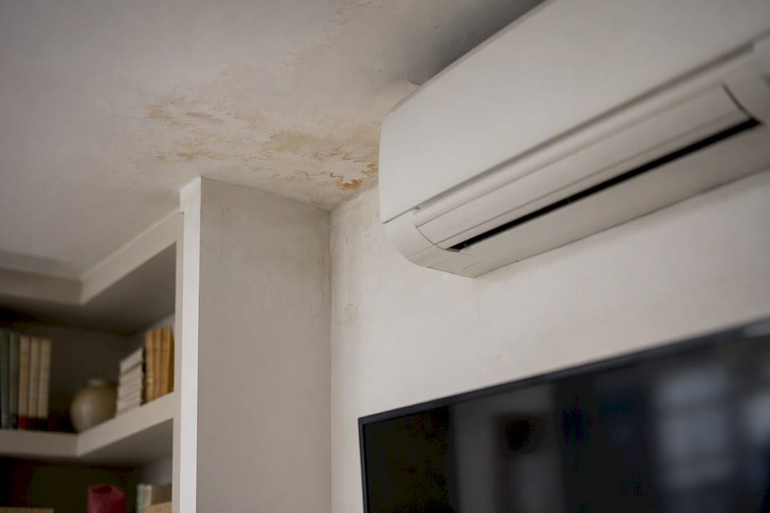 Moisture damage near aircon on wall and ceiling
