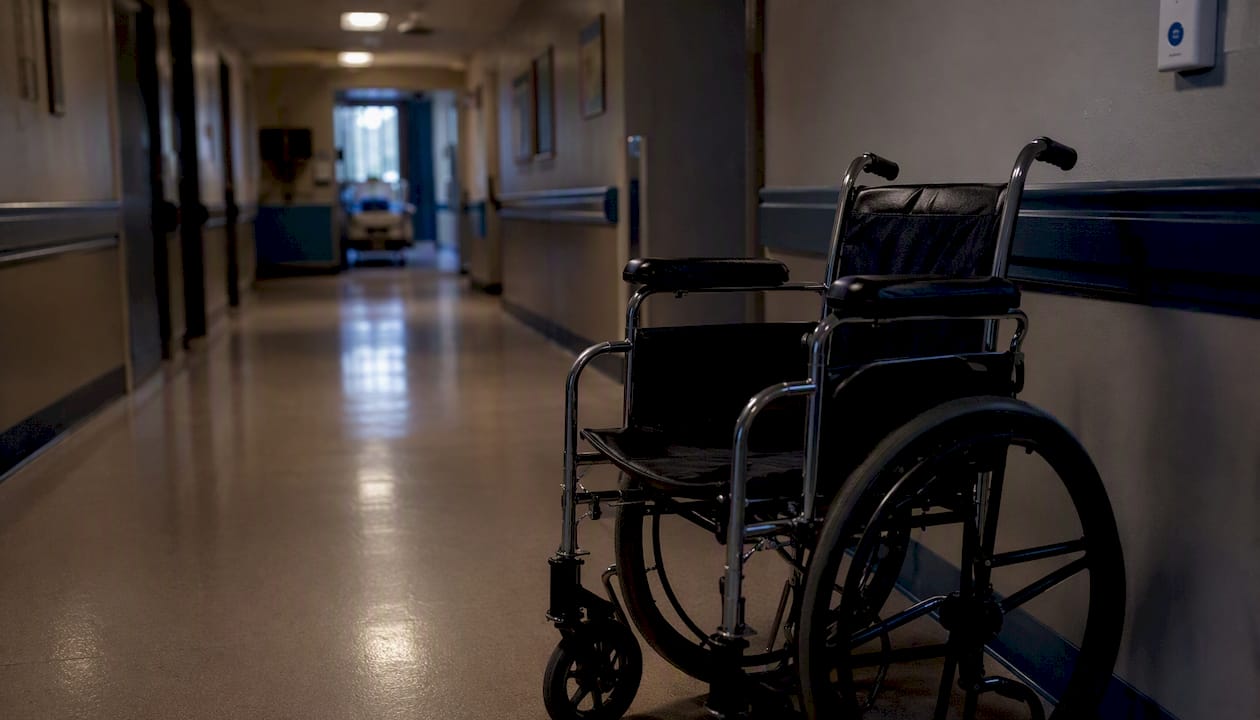 Empty wheelchair in care facility corridor
