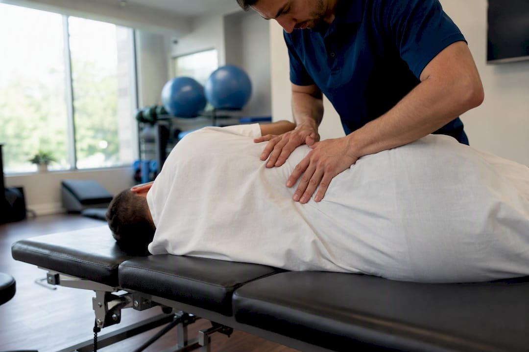 Physical therapist treating spinal cord injury patient