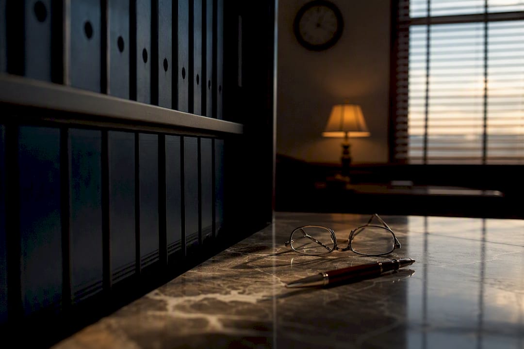 Desk with reading glasses and pen in law office