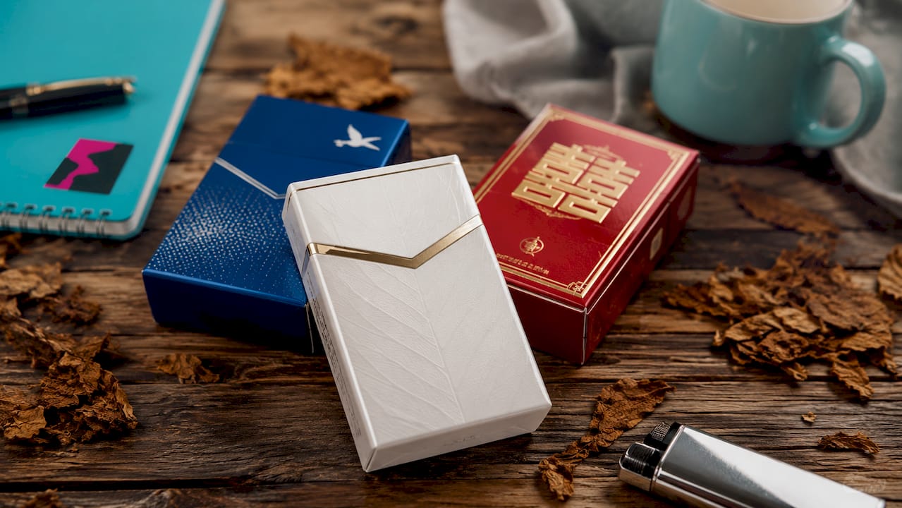 Close-up of premium cigarette packs on tobacco leaves