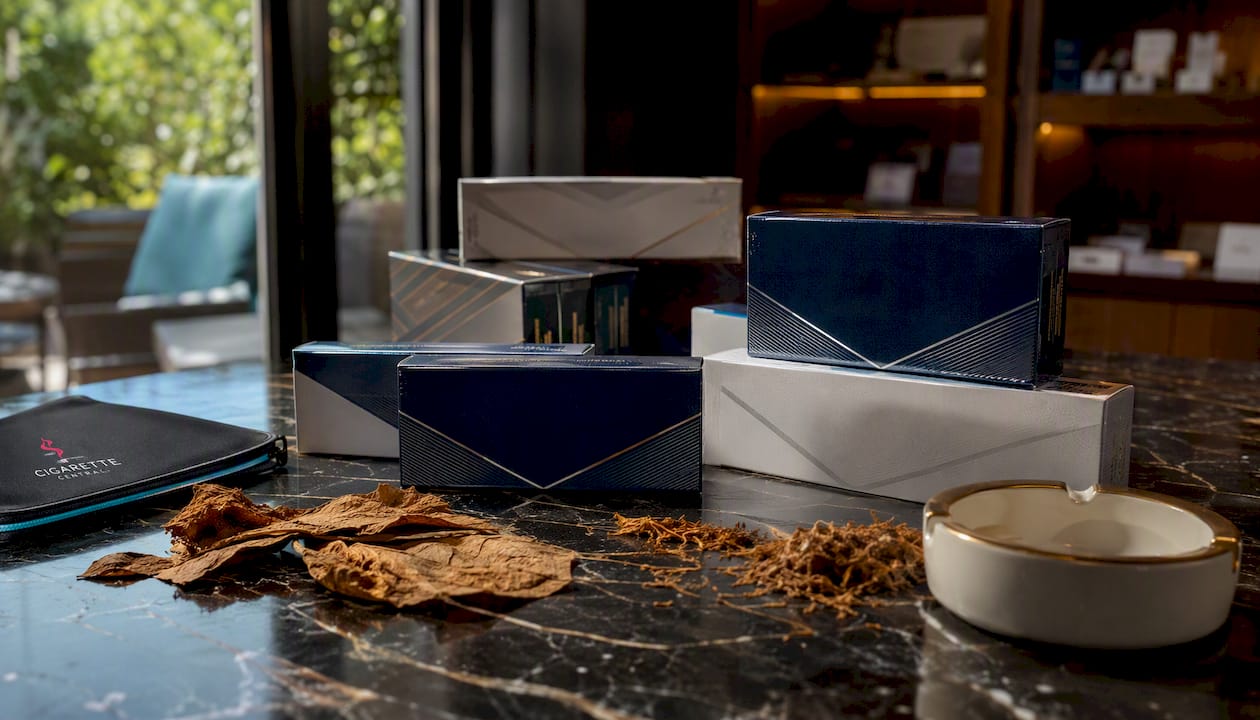 Close-up of cigarette cartons on marble shelf