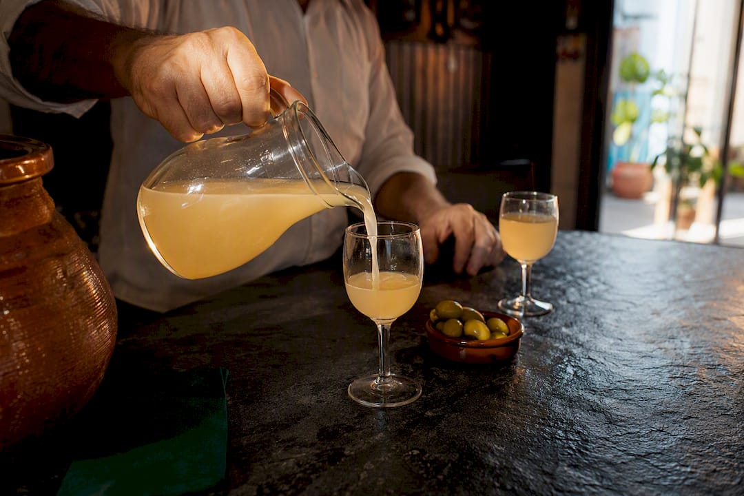 Server pouring chilled Spanish grape must