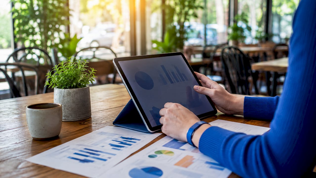 Hands typing on laptop with SEO reports nearby