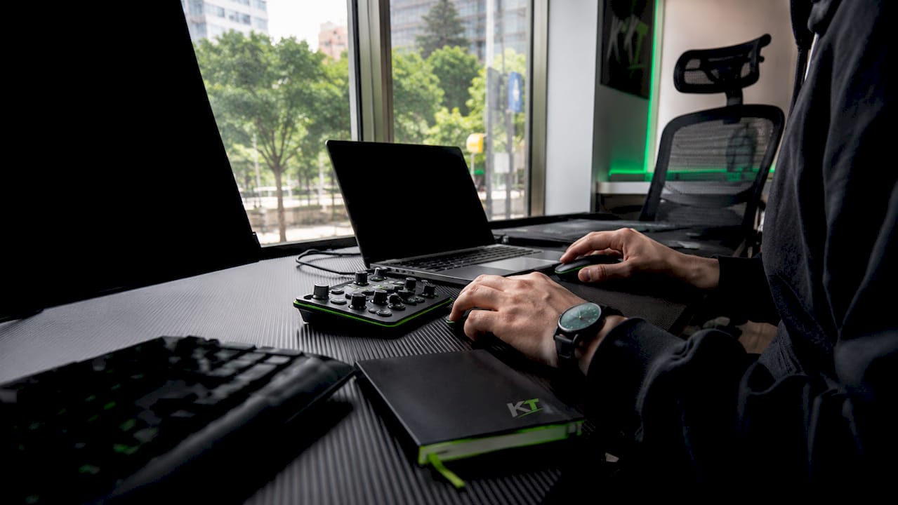 Hands adjusting external trading tools on desk