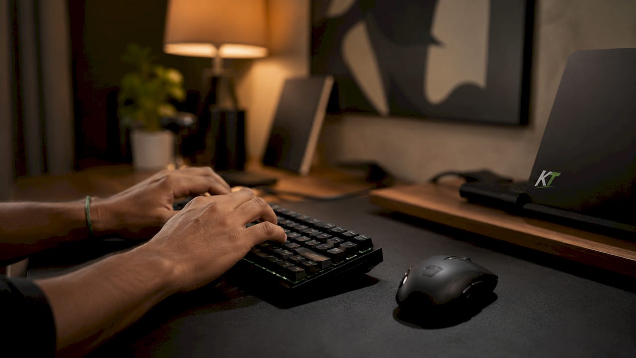 Close-up trader hands typing on mechanical keyboard