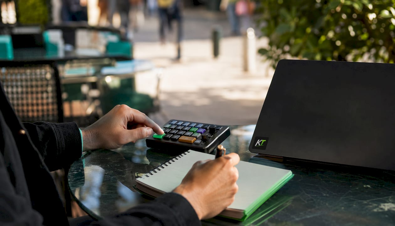 Hands using trading keypad with audit notes