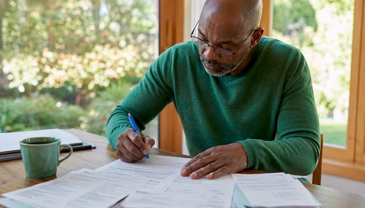 Man completing insurance prior authorization forms