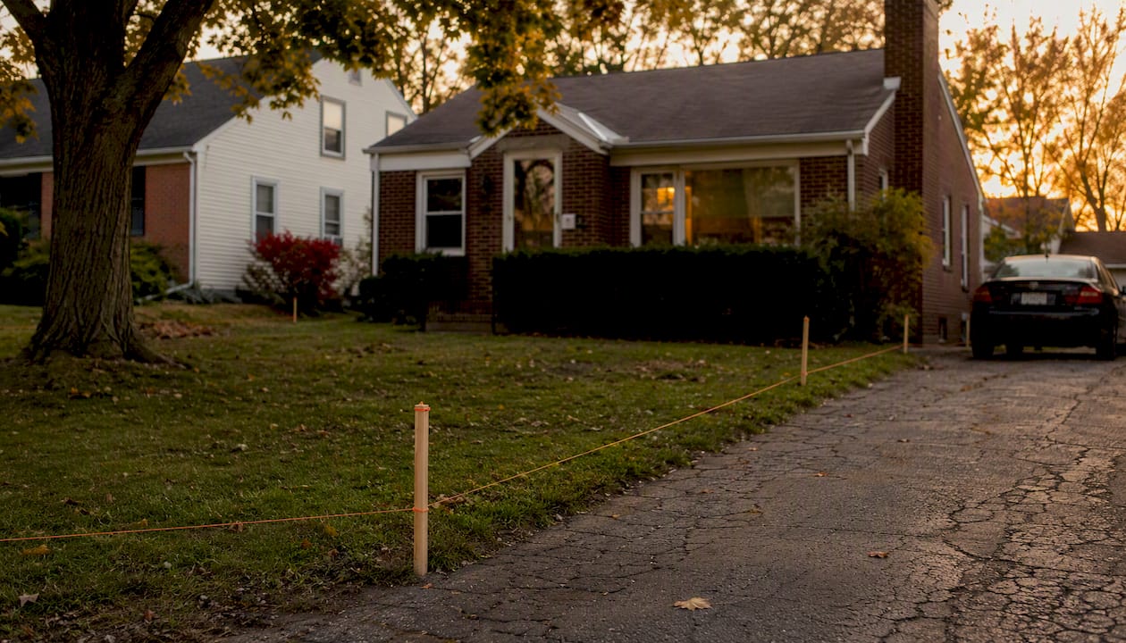 Older Michigan home with boundary markers