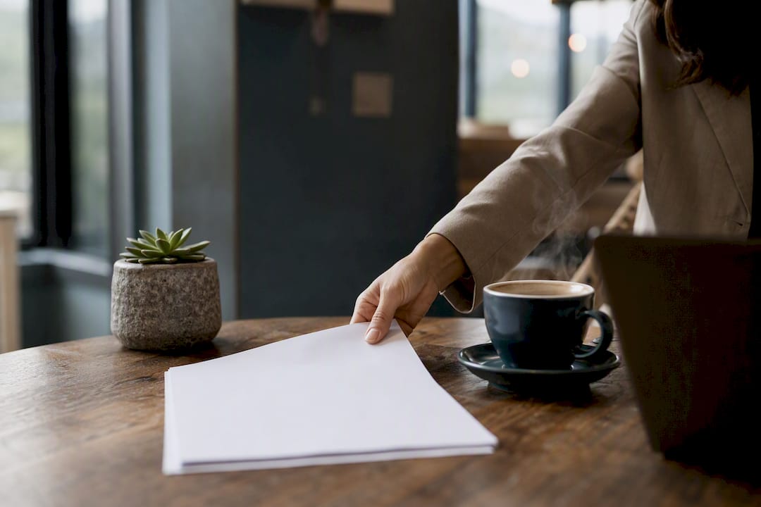 Hands placing SEO strategy printout on desk