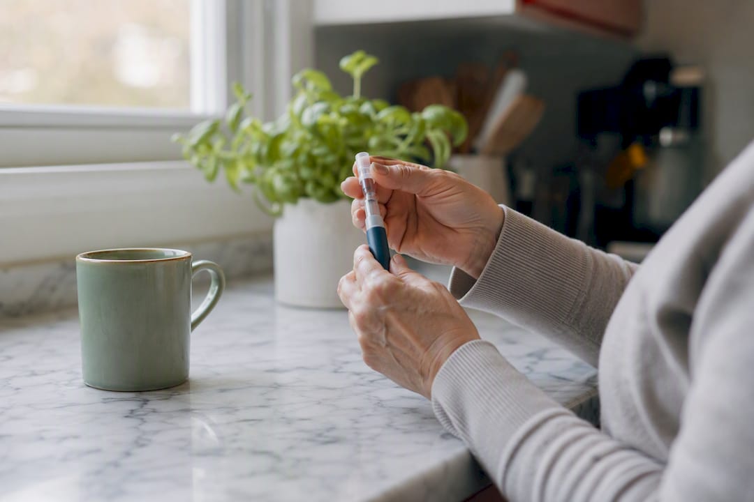 Hands preparing injection pen for GLP-1 medication