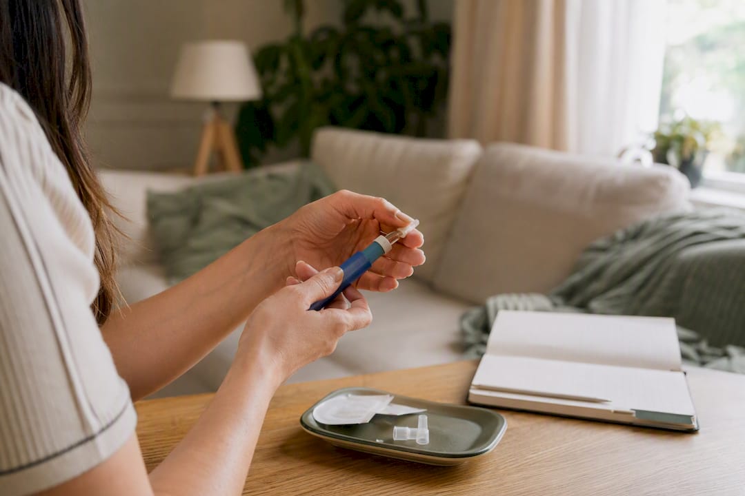 Hands preparing GLP-1 injection pen