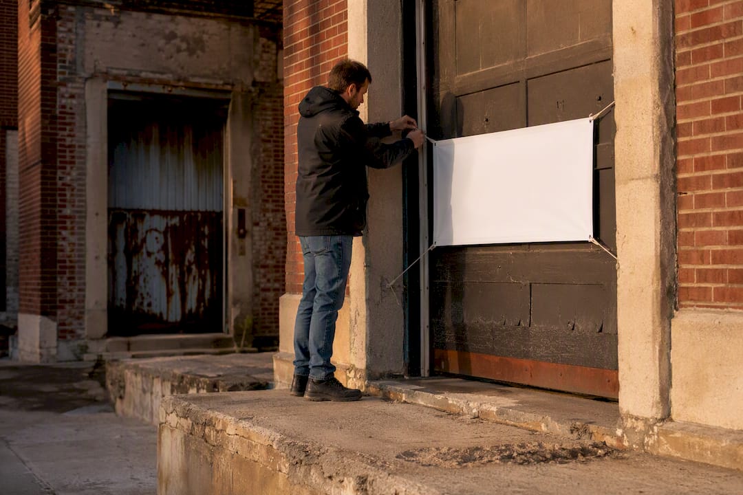 Hand placing reserved sign on apartment loading dock