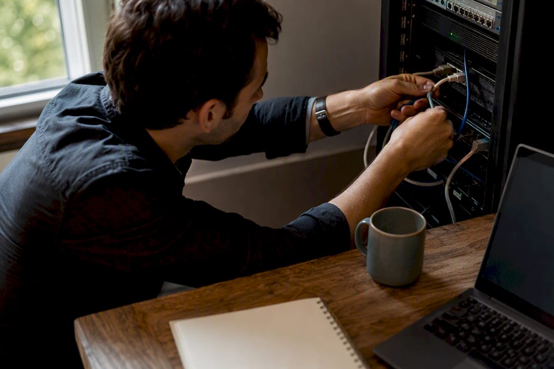 Hands adjusting network cables in warm office