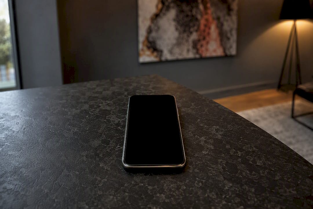 Smartphone face-up with dark screen on table