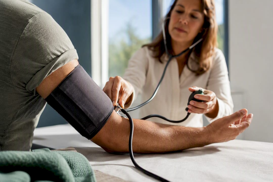 Clinician checking blood pressure with arm cuff