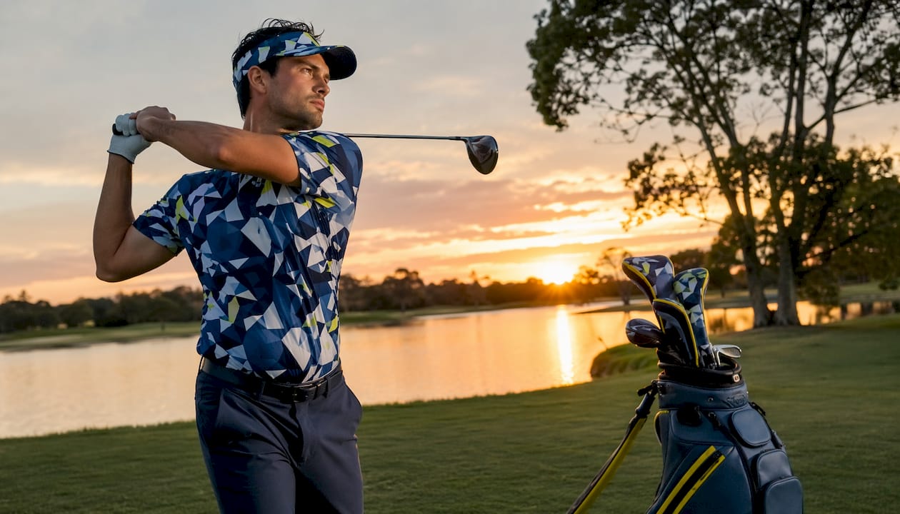 Golfer swinging in vibrant outfit on course