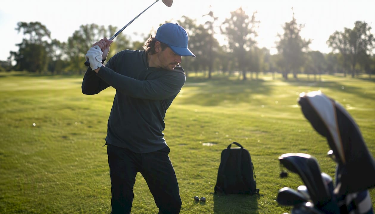 Golfer practicing swing in consistent kit