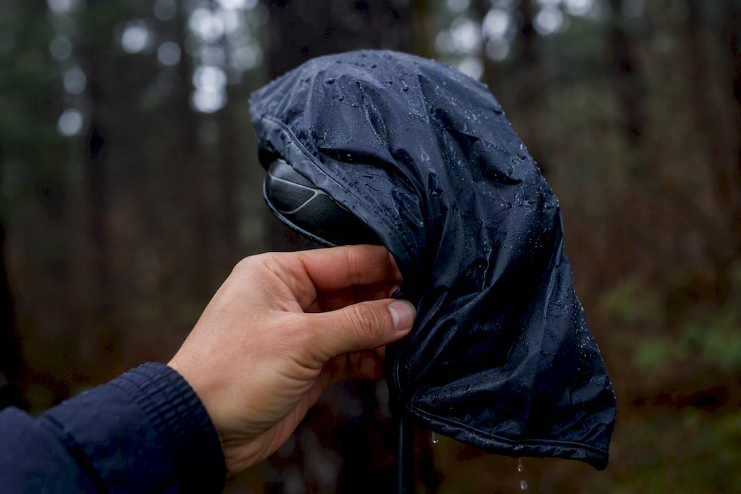 Hand fitting rain-resistant headcover onto club